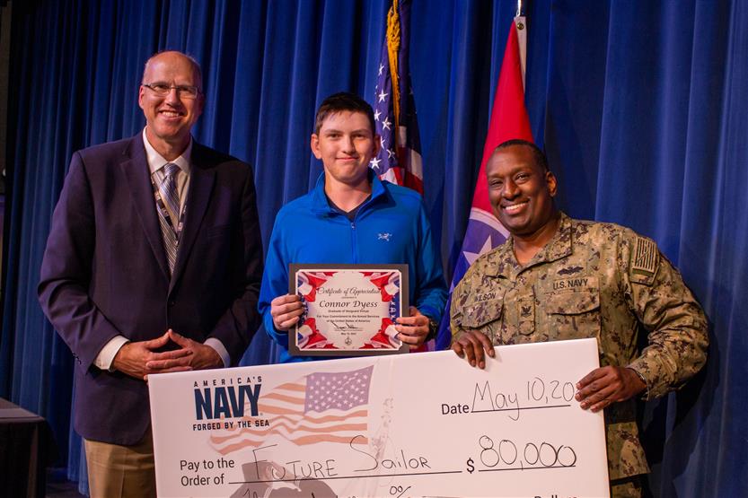 A student is honored for serving in the US Armed Forces after high school